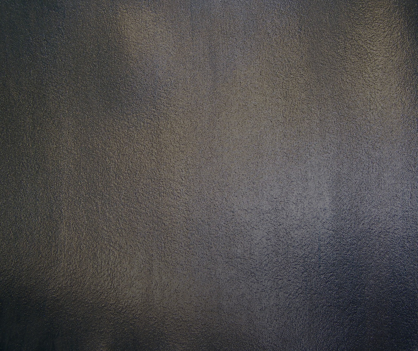 Textured dark surface with subtle variations.