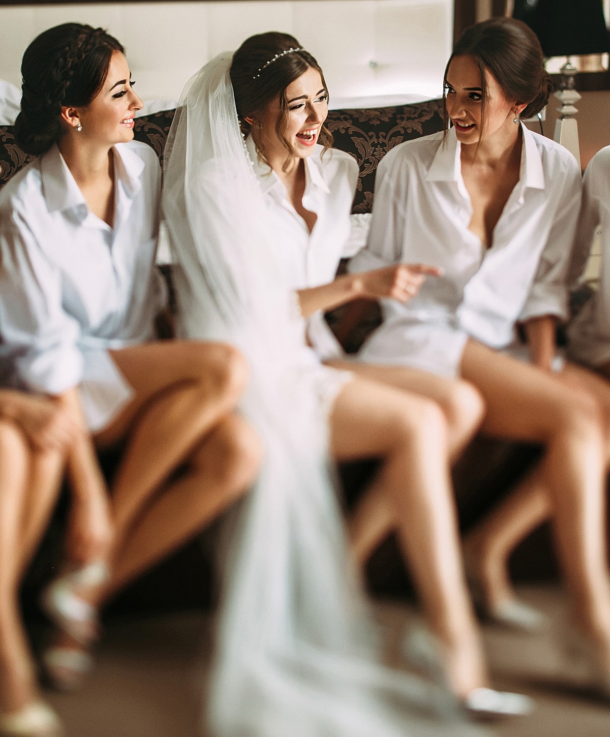 Smiling bride holding bouquet in elegant wedding dress.