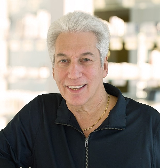 Smiling man in black jacket indoors