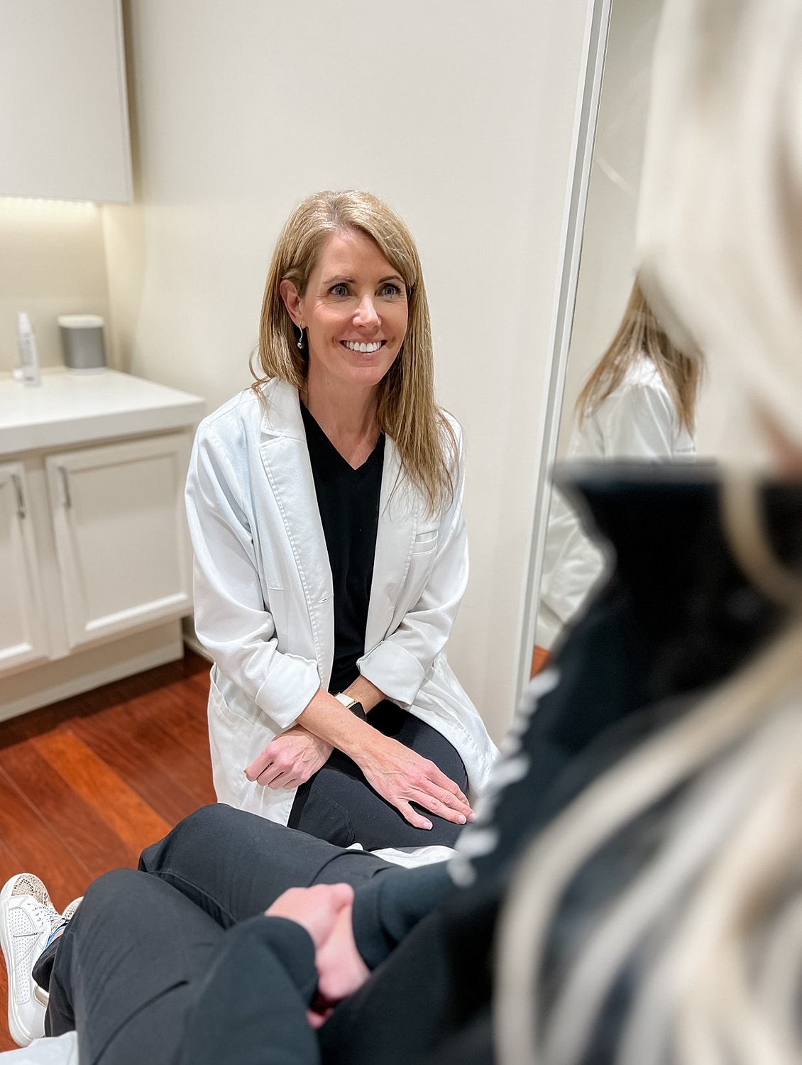 Smiling professional in medical office consultation.