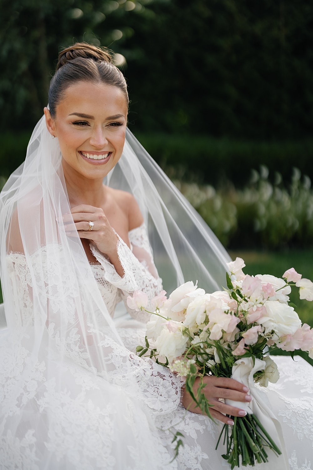 Woman posing in white activewear against neutral background.