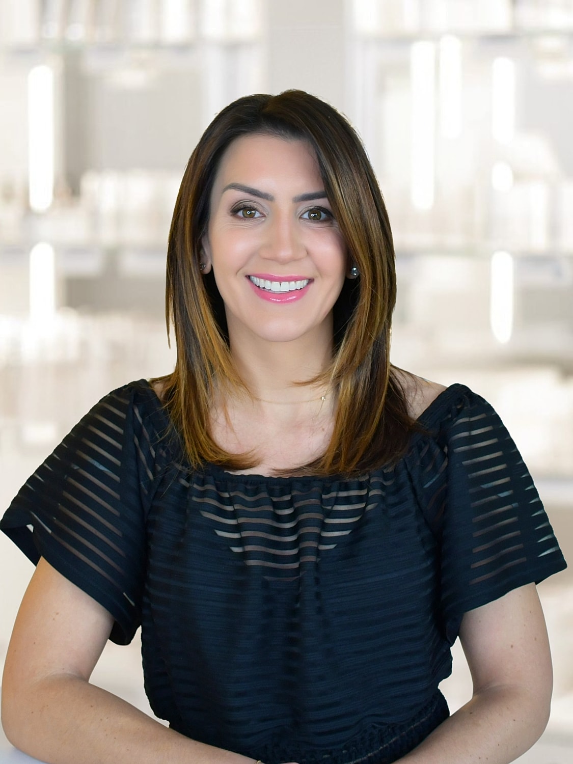 Nurse Tiffany smiling in professional attire.