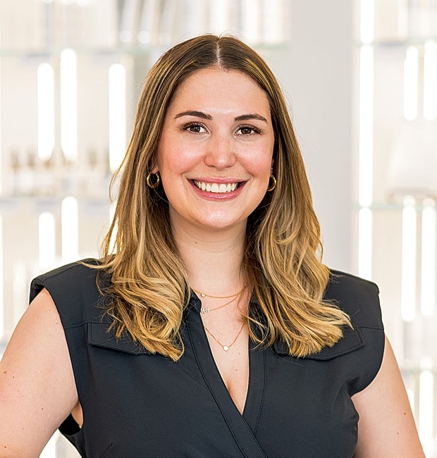 Smiling woman with long hair and necklace