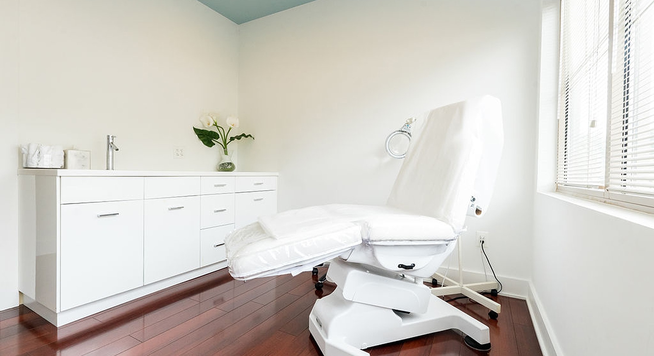 Clean and modern examination room with treatment chair.