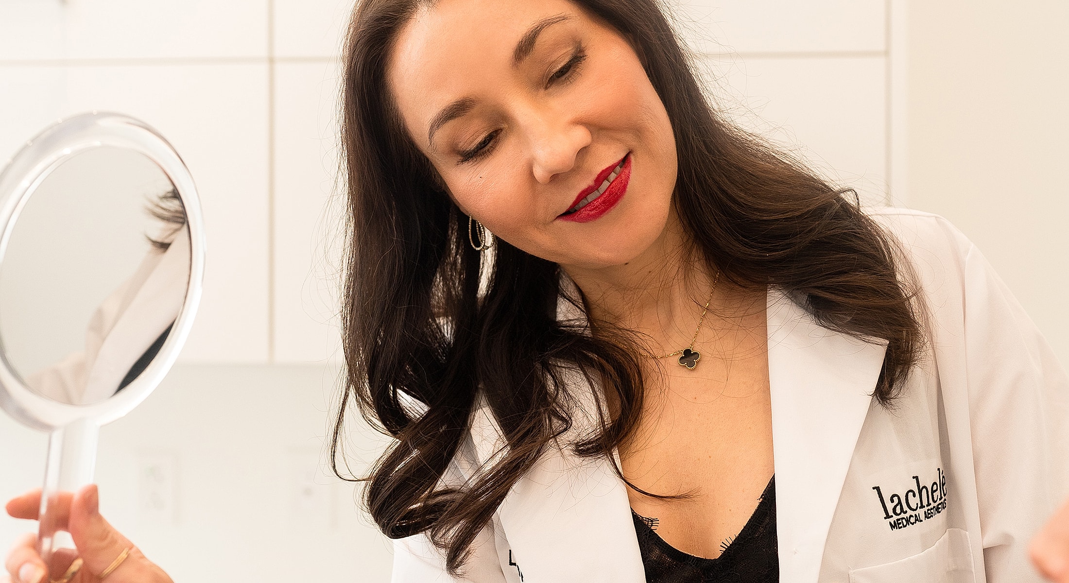 Professional woman examining her reflection in mirror.