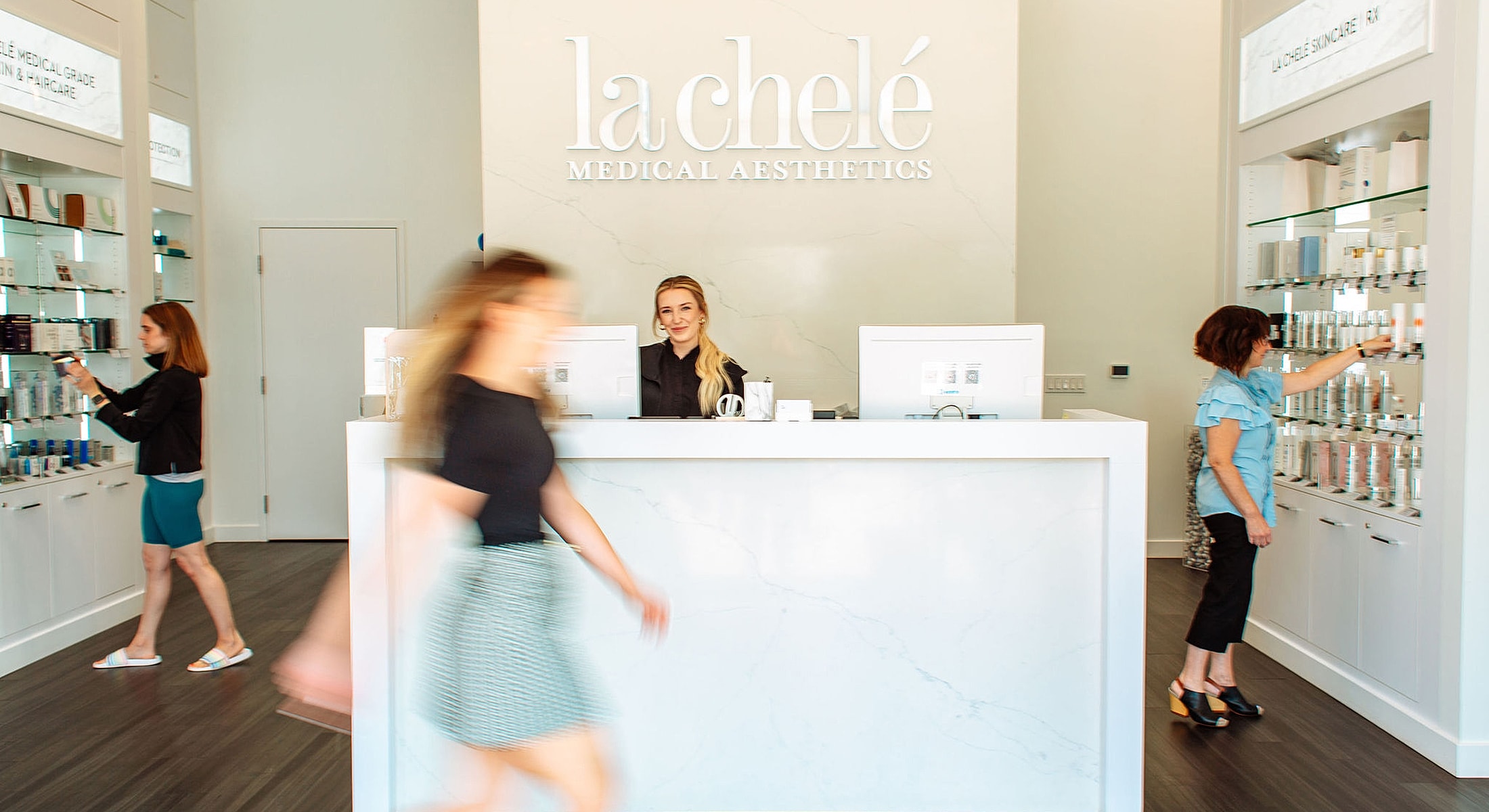Busy medical aesthetics clinic with staff and customers.