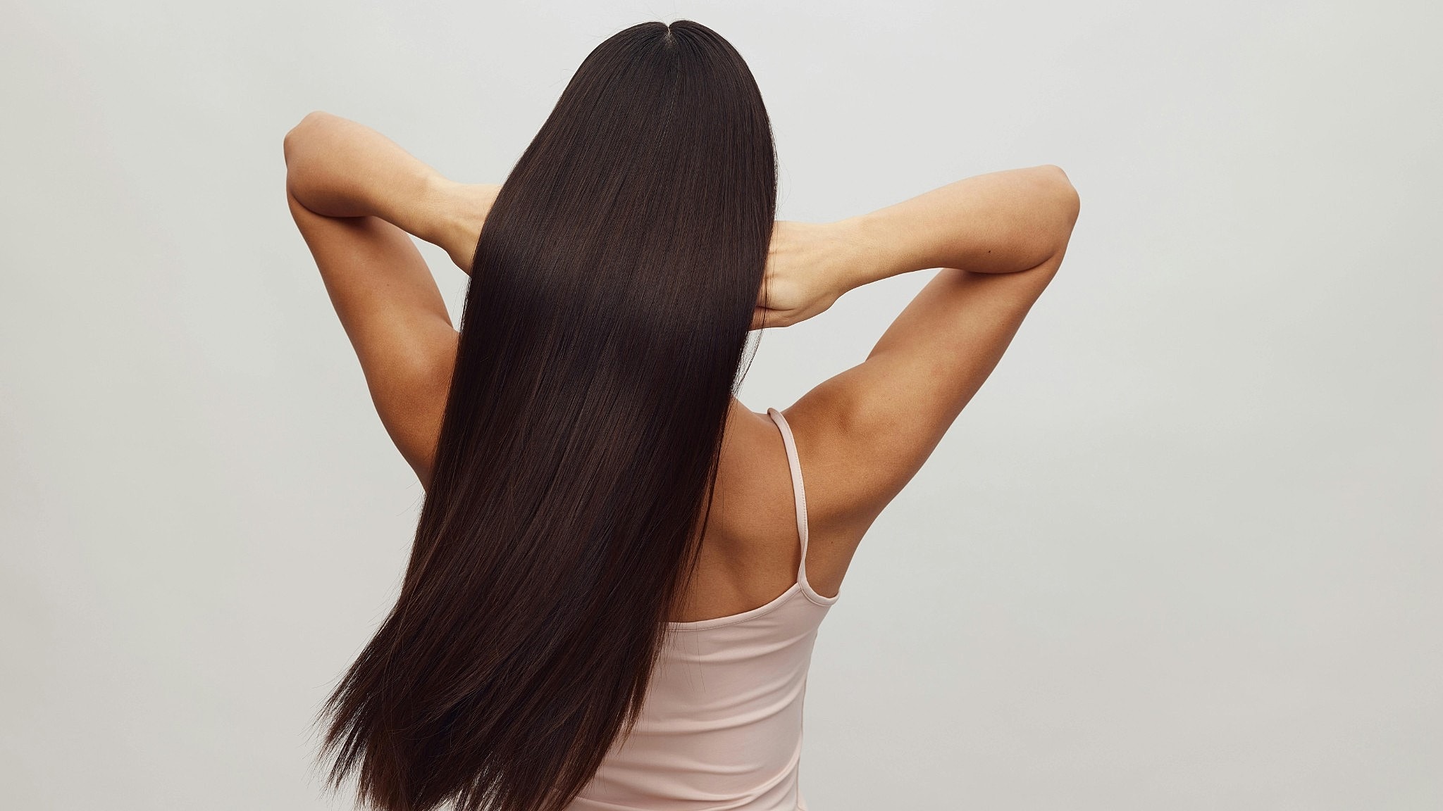 Woman with long, straight hair from behind.