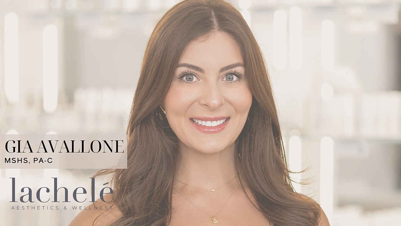 Smiling woman in medical aesthetics setting.