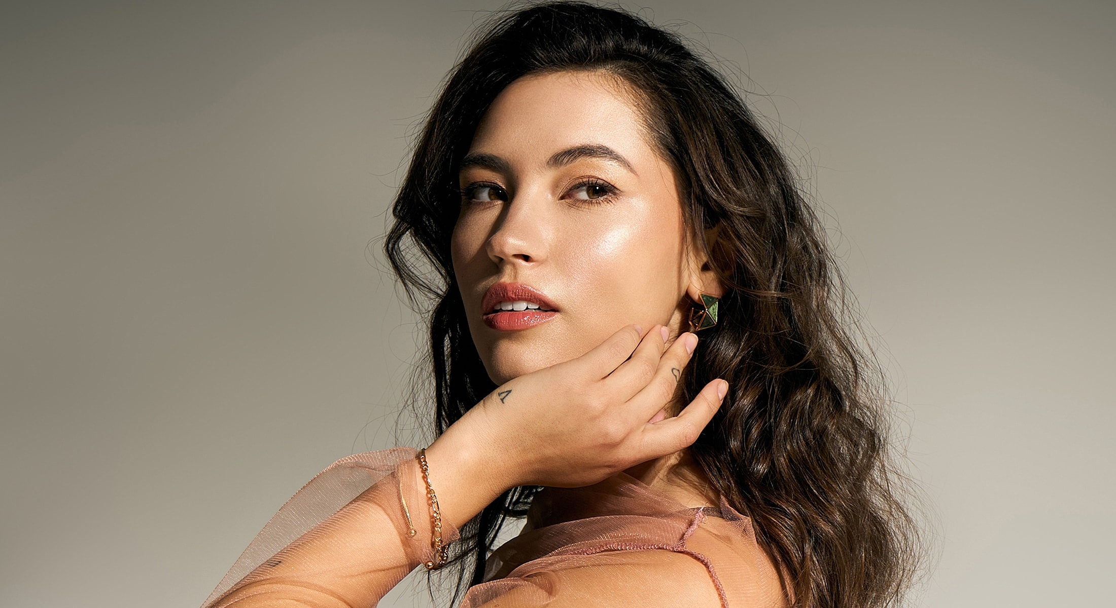 Woman with long hair posing elegantly.