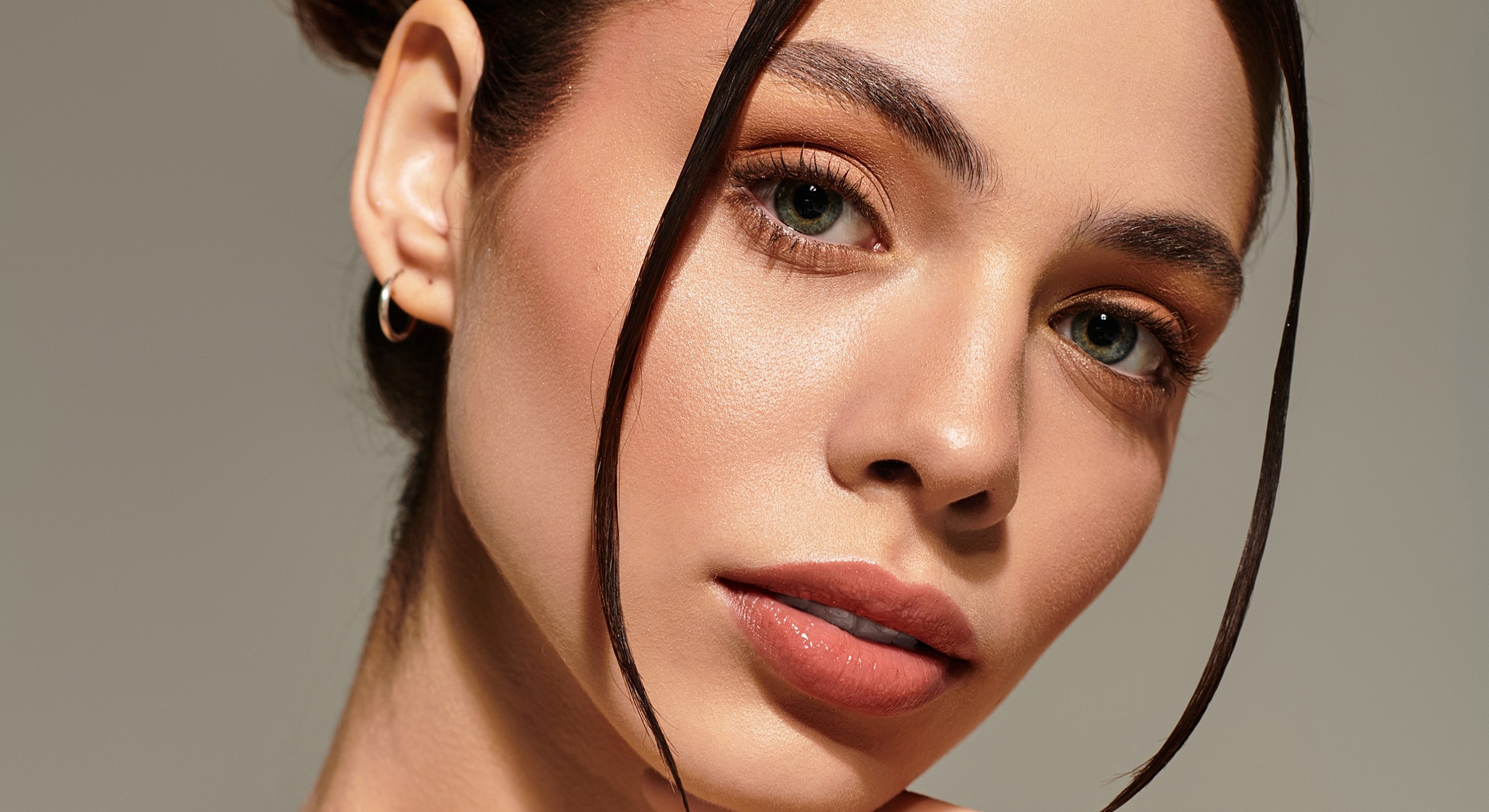 Close-up of a woman's face with natural makeup.